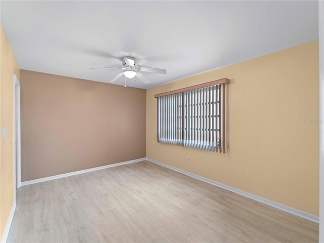 empty room featuring ceiling fan and light hardwood / wood-style flooring