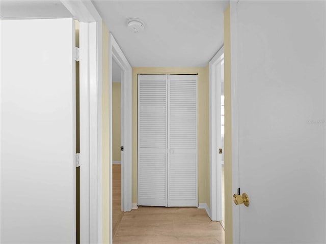 corridor with light hardwood / wood-style flooring