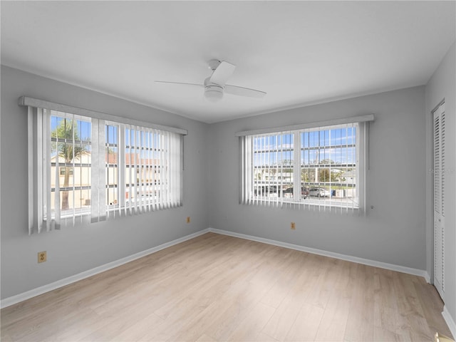 unfurnished room with ceiling fan, plenty of natural light, and light wood-type flooring