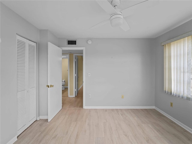 unfurnished bedroom featuring light hardwood / wood-style floors, a closet, and ceiling fan