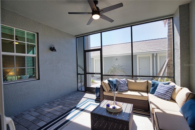 sunroom / solarium featuring a ceiling fan