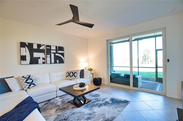 tiled living room featuring a ceiling fan and baseboards