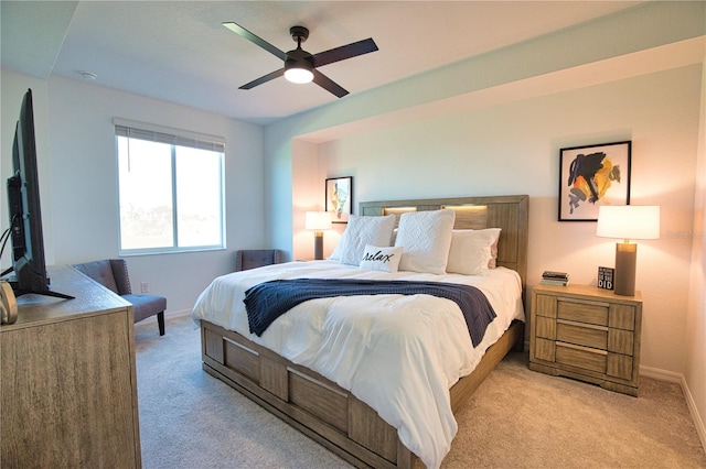 bedroom with baseboards, a ceiling fan, and light colored carpet