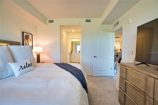 bedroom with ensuite bath, visible vents, and light colored carpet