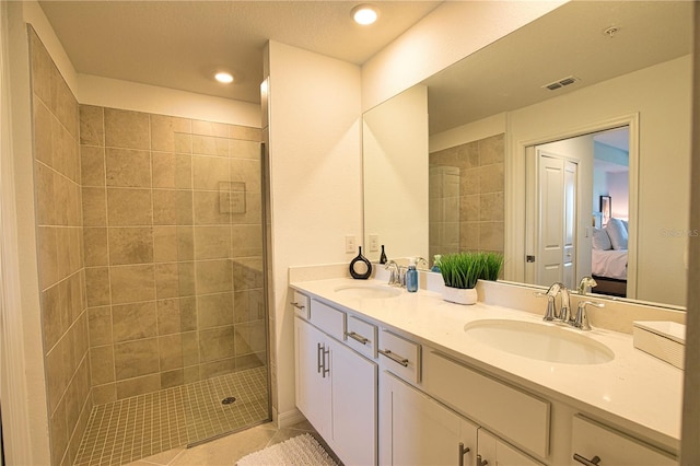 bathroom featuring double vanity, ensuite bath, a sink, and visible vents