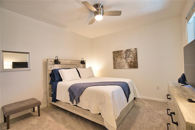 bedroom featuring light carpet, a ceiling fan, and baseboards