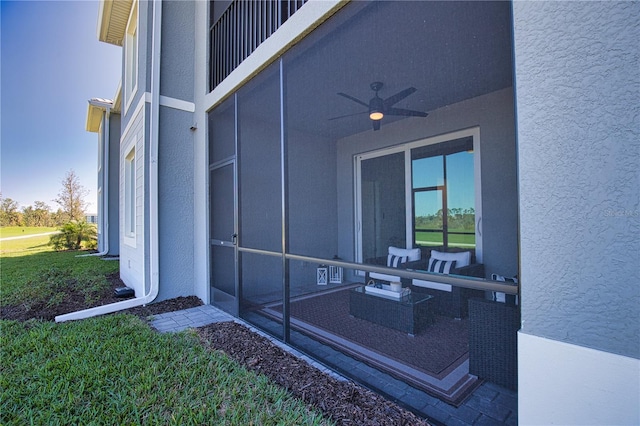 exterior space with ceiling fan and stucco siding