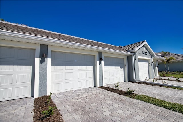 garage with decorative driveway