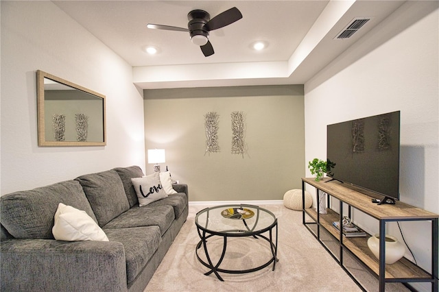 living room featuring ceiling fan, visible vents, and baseboards