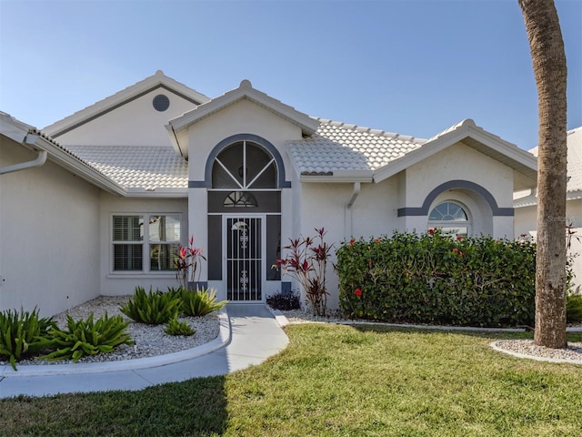 view of exterior entry featuring a yard