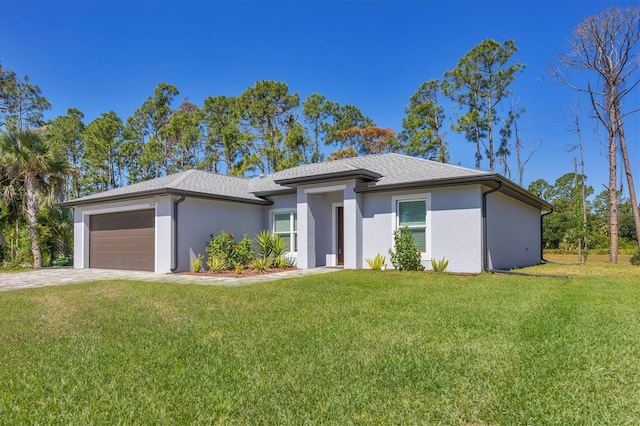 view of front of home with a garage and a front yard