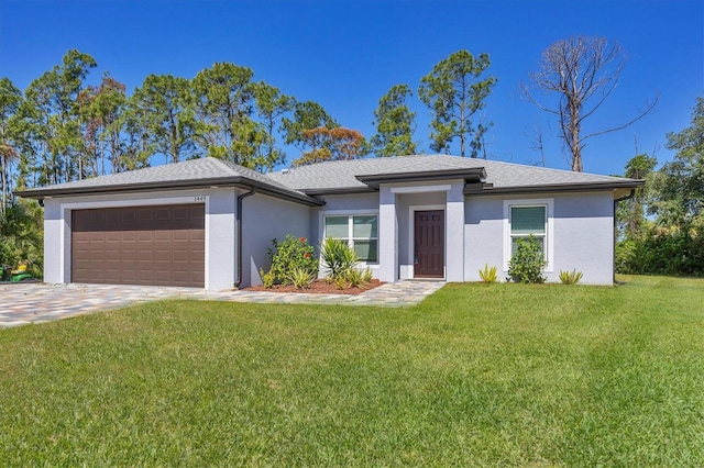 view of front of home featuring a garage and a front lawn