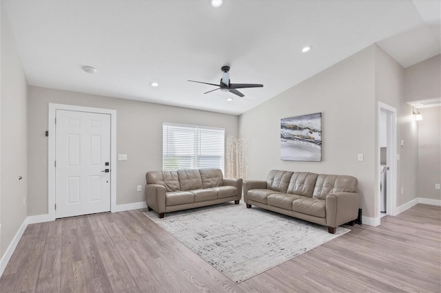 living room featuring vaulted ceiling, ceiling fan, and light hardwood / wood-style flooring