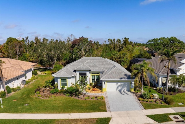 view of front of house featuring a garage and a front yard