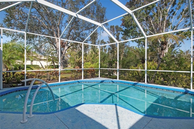 view of pool with glass enclosure