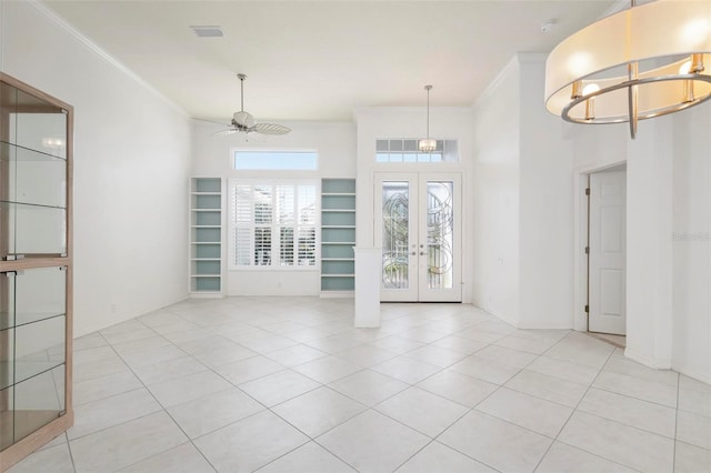 interior space with french doors, ceiling fan, ornamental molding, and light tile patterned flooring