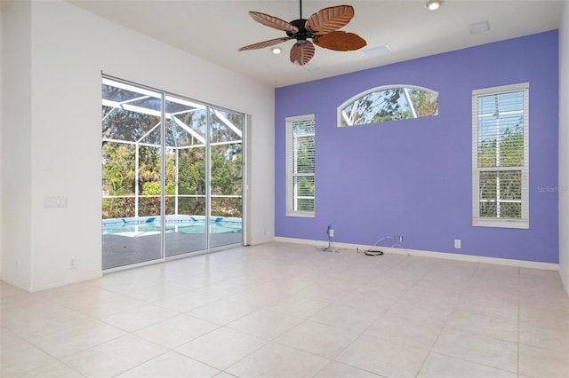 spare room featuring light tile patterned floors and ceiling fan