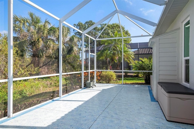 unfurnished sunroom with lofted ceiling