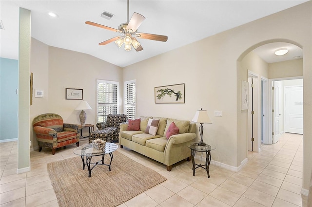 living room featuring light tile patterned flooring, lofted ceiling, and ceiling fan