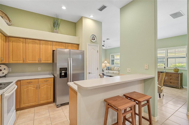 kitchen with a breakfast bar, white electric stove, kitchen peninsula, and stainless steel fridge with ice dispenser