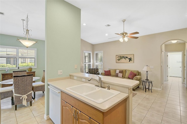 kitchen featuring sink, decorative light fixtures, light tile patterned floors, white dishwasher, and ceiling fan