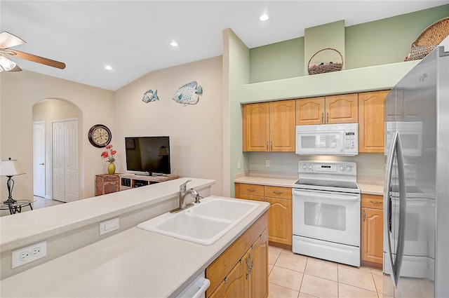 kitchen with lofted ceiling, sink, white appliances, ceiling fan, and light tile patterned flooring