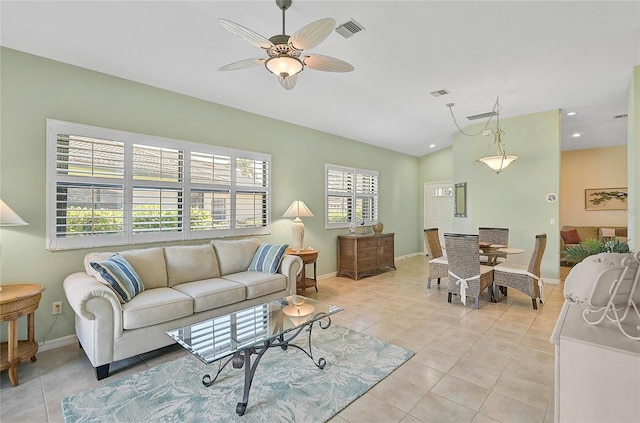 tiled living room featuring ceiling fan