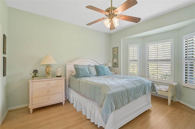 bedroom with ceiling fan and light hardwood / wood-style flooring