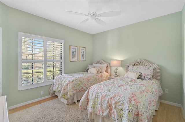 bedroom with light hardwood / wood-style floors and ceiling fan