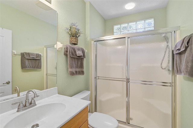 bathroom featuring vanity, toilet, and an enclosed shower