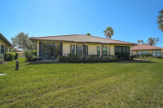 rear view of house featuring a lawn