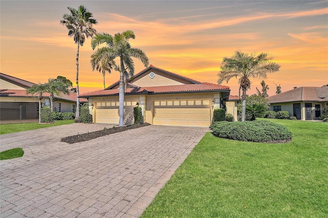 view of front of house featuring a garage and a yard