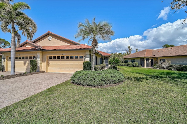 view of front of house with a garage and a front lawn