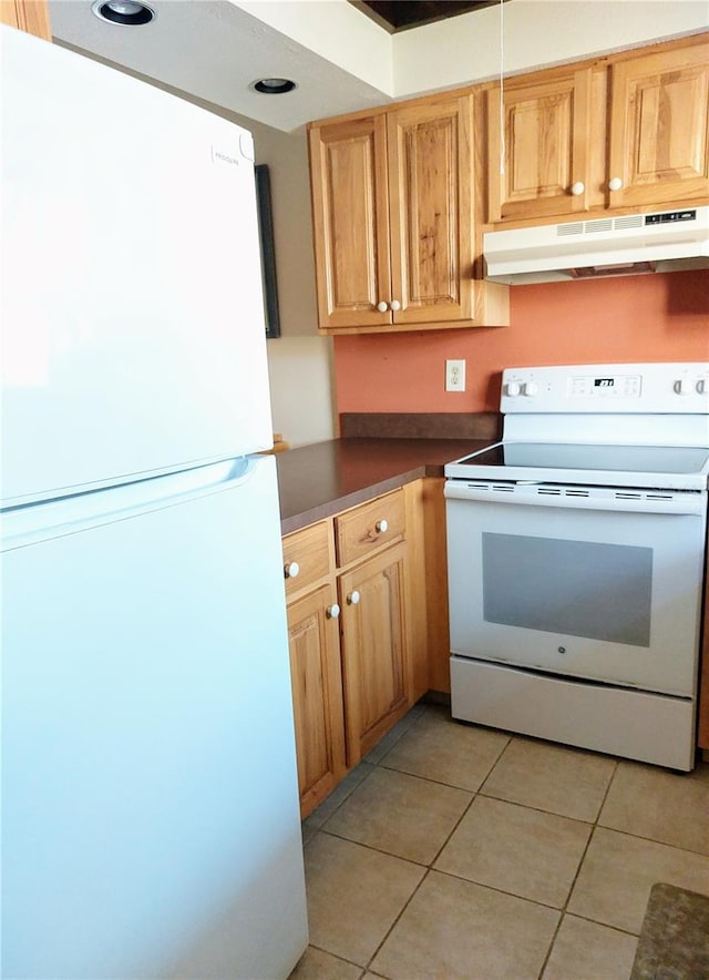 kitchen featuring light tile patterned floors and white appliances