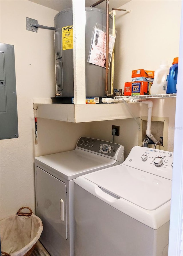 clothes washing area featuring washing machine and clothes dryer, electric panel, and water heater