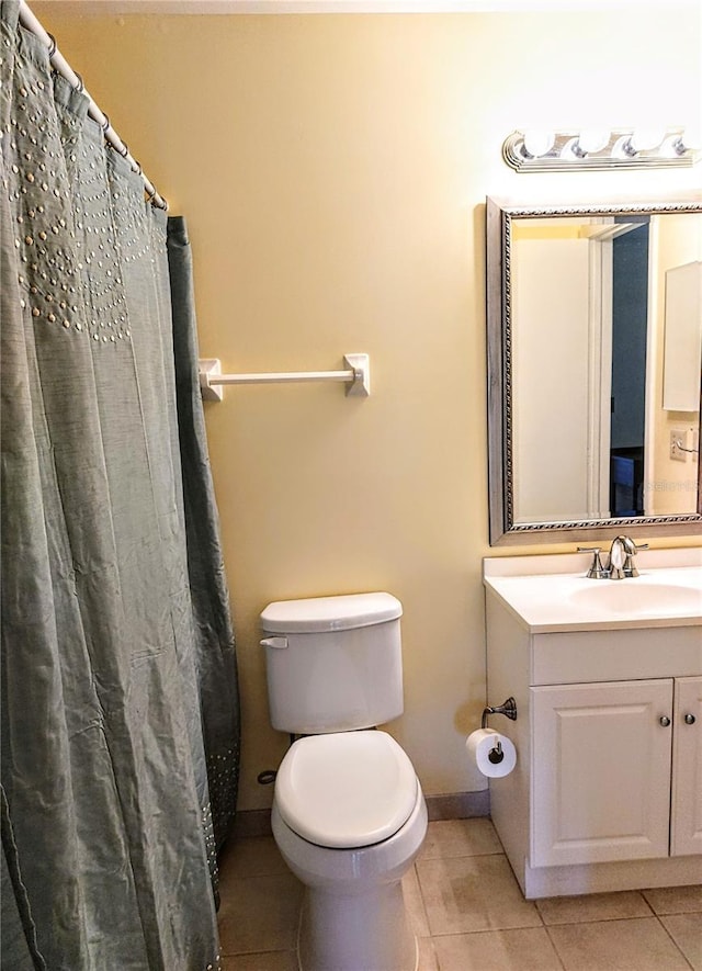 bathroom featuring vanity, toilet, curtained shower, and tile patterned flooring