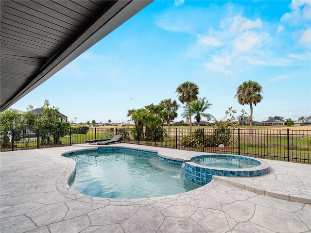 view of swimming pool with a patio, a fenced backyard, and a pool with connected hot tub