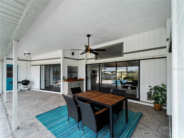 view of patio / terrace featuring a grill, outdoor dining area, and a ceiling fan