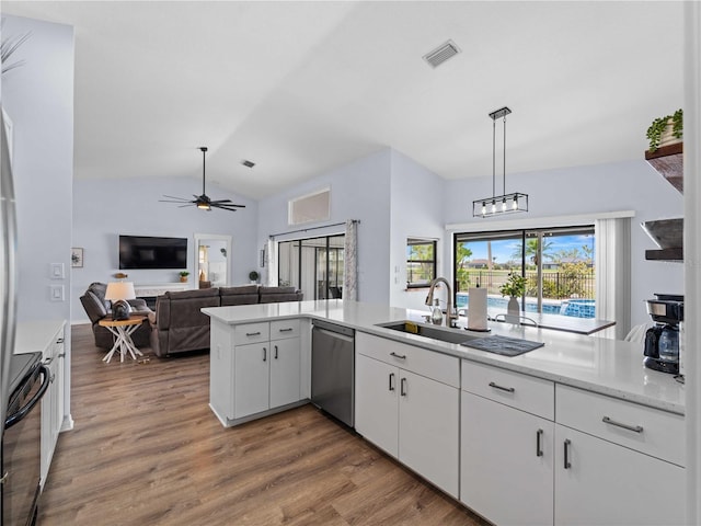 kitchen featuring lofted ceiling, white cabinets, wood finished floors, range, and dishwasher