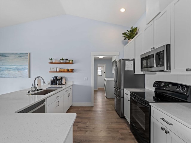 kitchen with stainless steel appliances, washer / clothes dryer, white cabinetry, and a sink