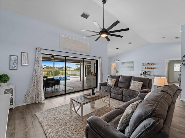 living area with a ceiling fan, visible vents, and wood finished floors