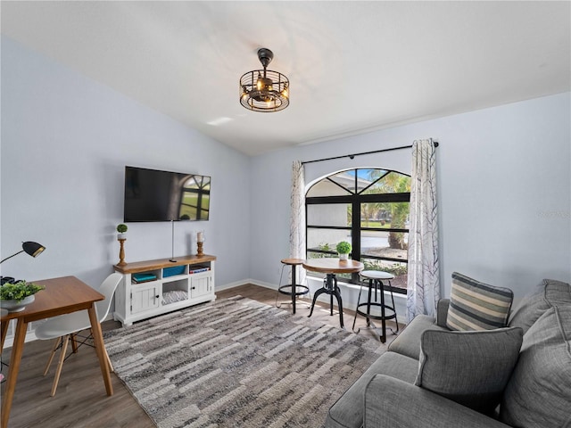 living room with lofted ceiling, baseboards, and wood finished floors