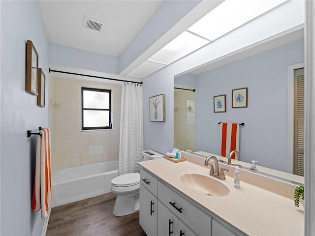 bathroom with visible vents, shower / bathtub combination with curtain, toilet, vanity, and wood finished floors