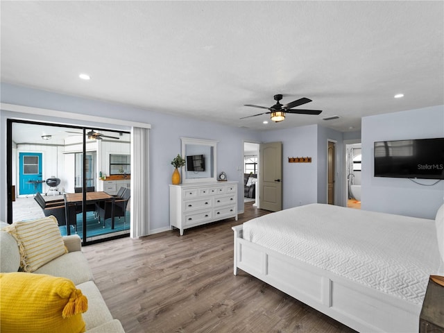 bedroom with recessed lighting, wood finished floors, visible vents, and access to exterior