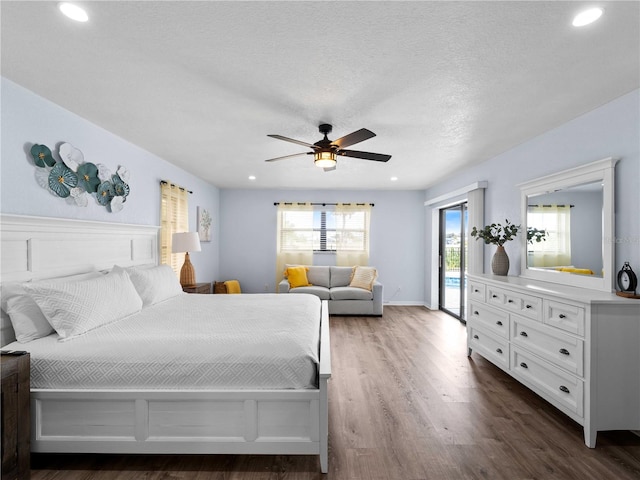 bedroom featuring a textured ceiling, ceiling fan, recessed lighting, dark wood-type flooring, and access to exterior