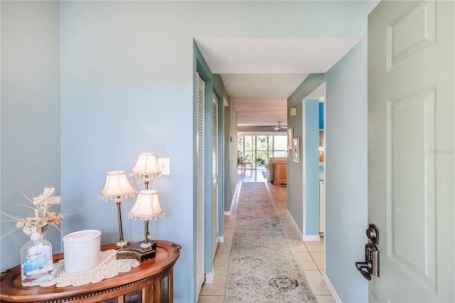 corridor featuring light tile patterned floors