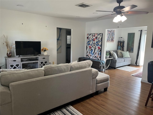 living room featuring dark hardwood / wood-style floors and ceiling fan