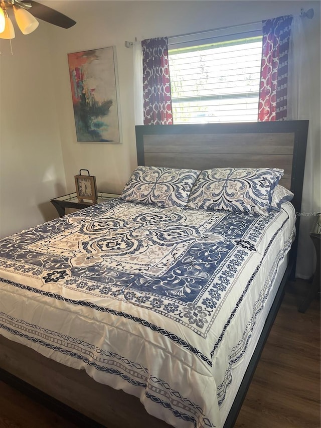 bedroom featuring dark hardwood / wood-style flooring and ceiling fan