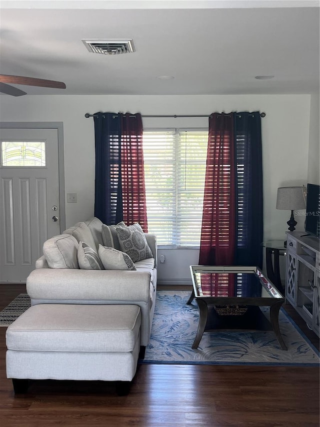 living room with wood-type flooring and ceiling fan