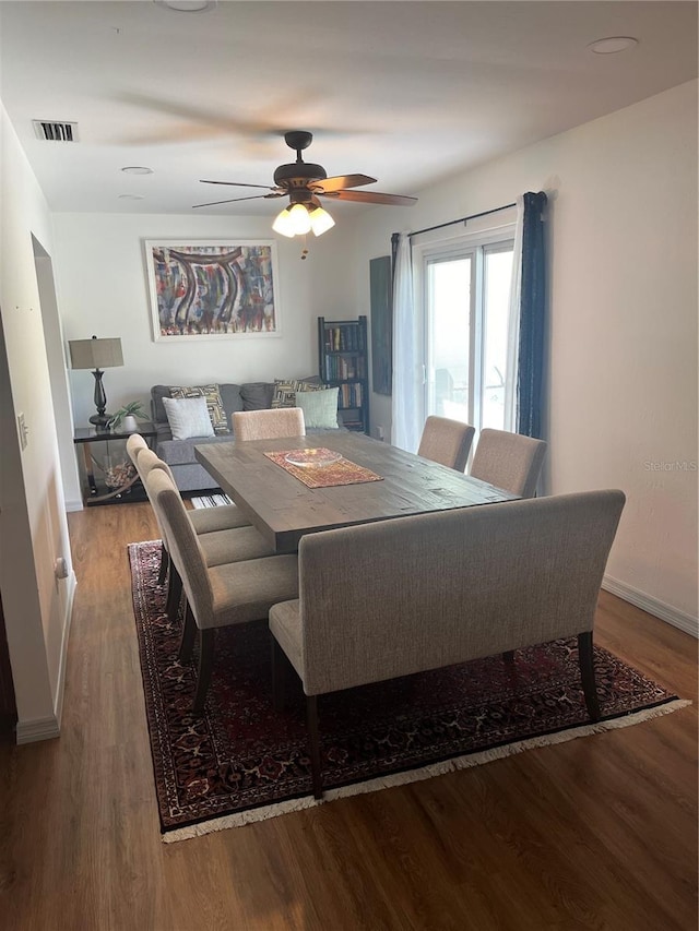 dining space with wood-type flooring and ceiling fan